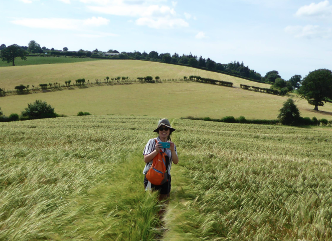 A photo of me hiking in a field.